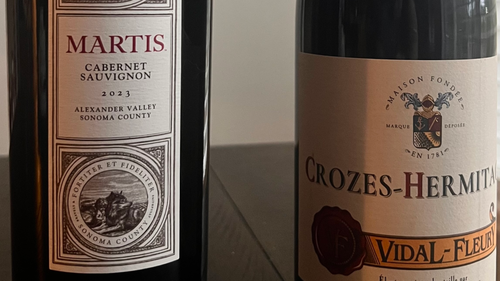 Two wine bottles side by side showing different label styles from New World and Old World wines