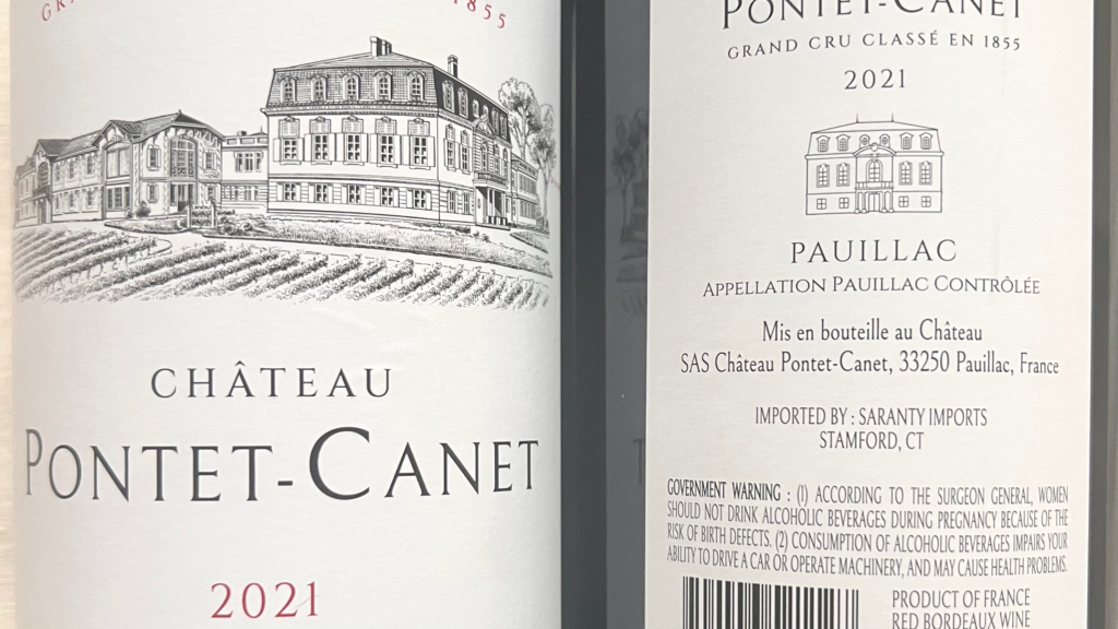 Close up of a Bordeaux wine label showing Pauillac appellation and Grand Cru Classification